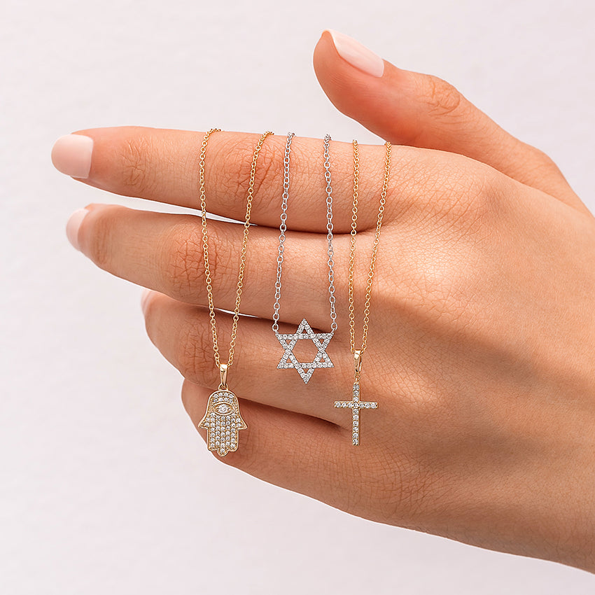 850x850_FLUFF_MEDIA_YG_Hamsa_Diamond_Necklace__YG_Cross_Diamond_Necklace__SLV_Star_of_David_Necklace_model_fj.webp